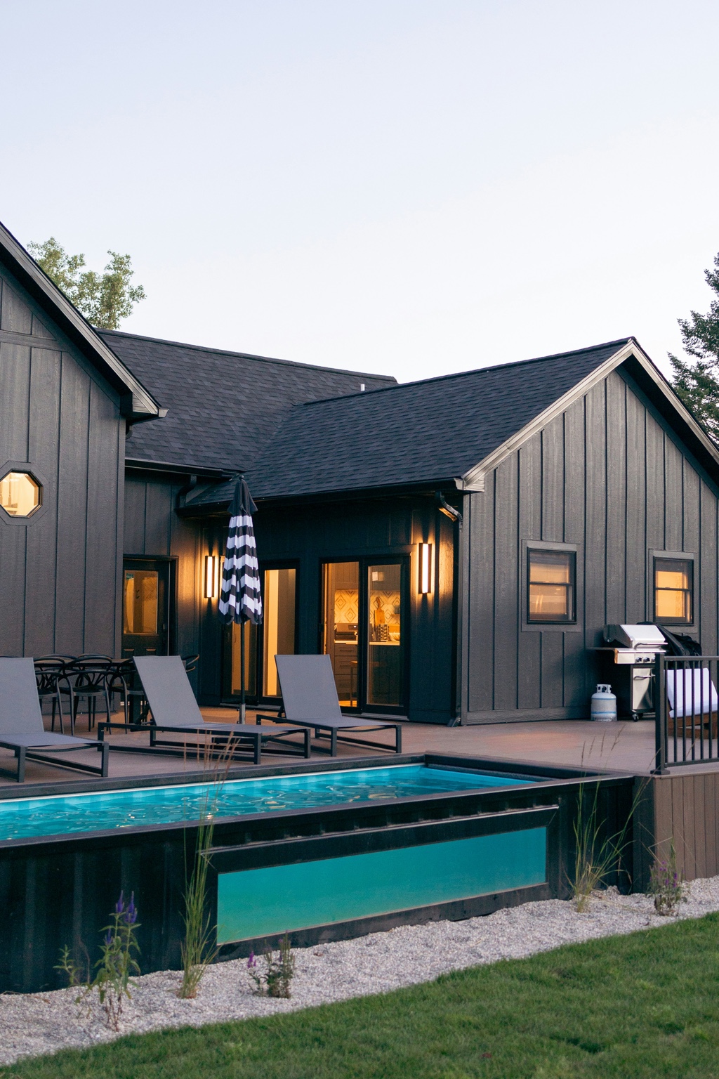 Contemporary residence with illuminated outdoor swimming pool and lounge terrace